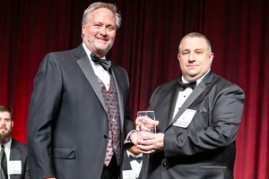 Brian Rowden receiving the award