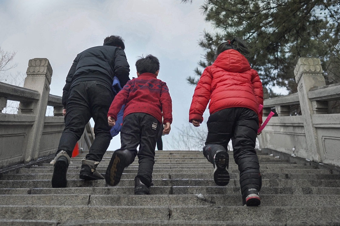 Family walking up the stairs in Benxi