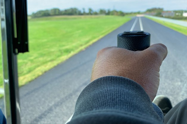 Machine on road, focus on joystick
