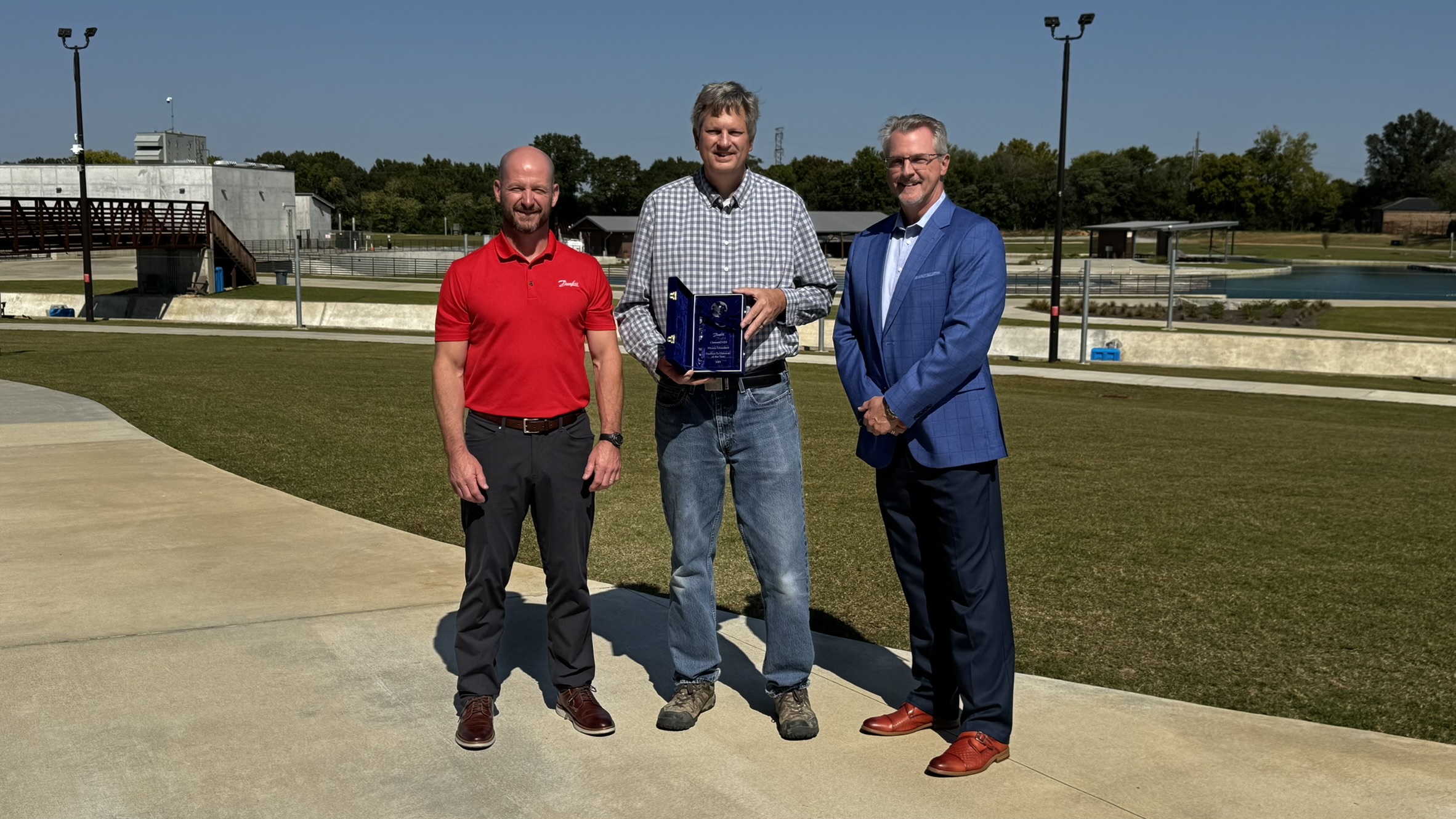 Jon Harwood, regional sales manager at Danfoss Drives (left) and Joseph Halliday, sales director at Danfoss Drives (right) present Jacob Clawson, business development manager at Cloward H2O with the EnVisioneer of the Year award in the Consultant category.