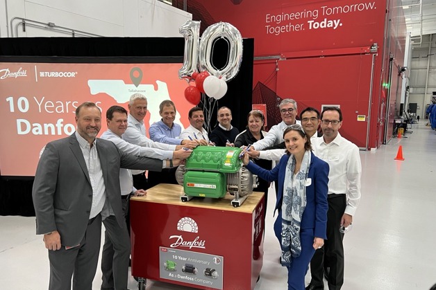 The Danfoss global executive team and Turbocor leaders sign the cover of a TGS compressor at the 10th anniversary employee celebration.