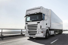 A tractor trailer driving down the highway representing transportation refrigeration solutions by Danfoss