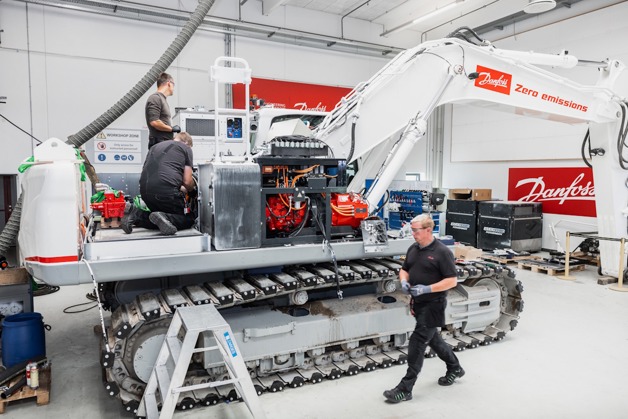 Danfoss technicians working on excavator conversion
