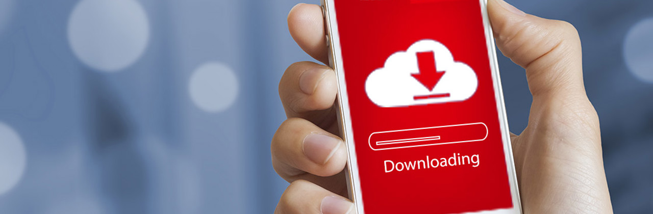 Photo of a hand holding a smartphone with a Danfoss app running on the screen of the phone.