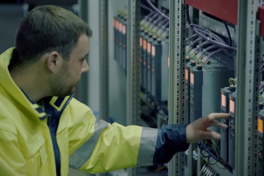 Worker assessing a variable speed drive