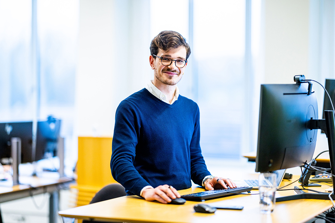A woman who stands and work on software code