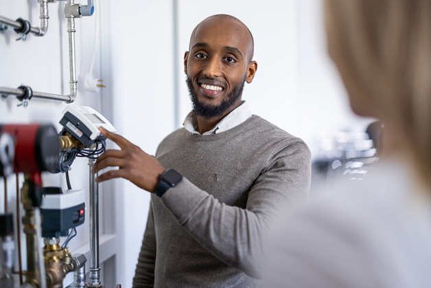 Service man looking at the Danfoss documentation