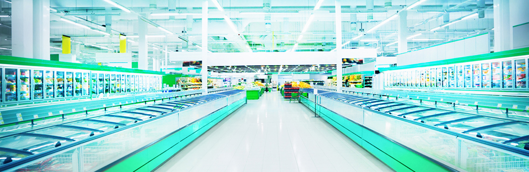 Inside a supermarket with long rows of refrigerators