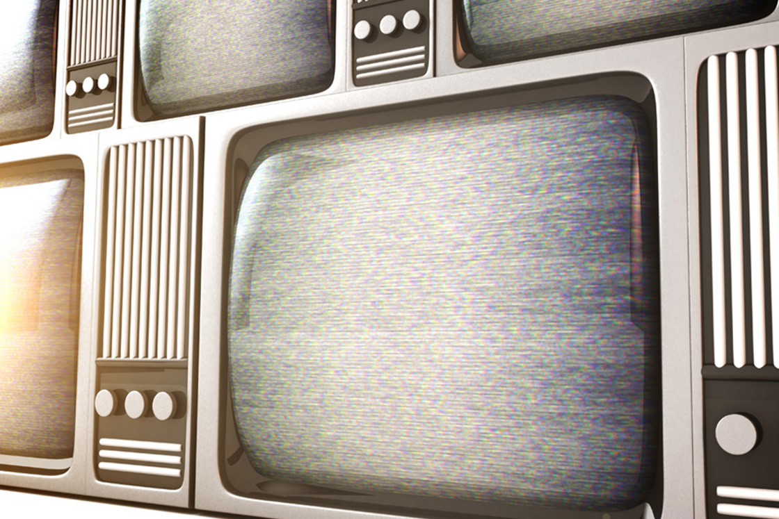 Row of old fashioned televisions with electromagnetic interference on the screens