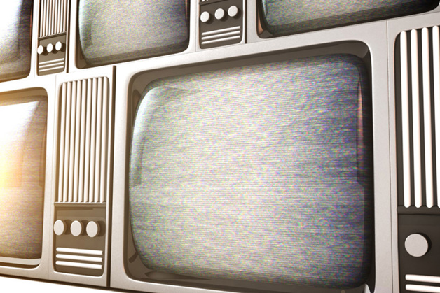 Row of old fashioned televisions with electromagnetic interference on the screens